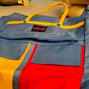 Fashion Club tote with wheels. Red, yellow, and blue. Few scratches